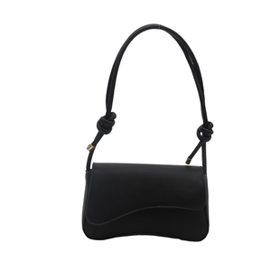 Modern black matte leather shoulder bag with unique asymmetric wavy flap and knotted strap