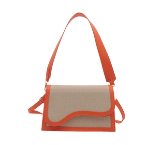Canvas shoulder bag with orange leather trim and wavy flap design on white background