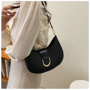 Detail of black crocodile texture crescent bag with golden D-shaped metal buckle