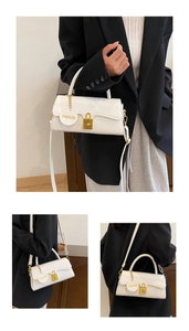 Close-up of white crossbody bag with gold lock and 'FASHION' tag showing multi-angle details