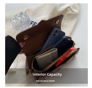 Detail view of the brown leather bag interior showing capacity for two phones and a wallet