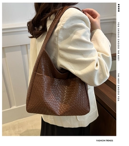 Detail of dark brown woven texture on a large capacity hobo shoulder bag for women
