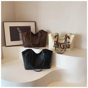 Multiple textured leather tote bags in brown, white and black colors with HNK BAG logo