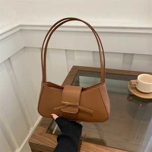 Caramel brown bow baguette bag for women, retro PU leather shoulder bag held by hand