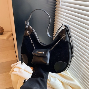 Modern black leather hobo bucket bag with a stylish pendant mini pouch and adjustable strap