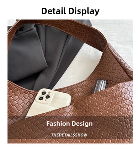 Macro shot of brown woven leather tote bag showing large capacity for phone and lipstick