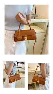 Detail of retro brown leather handbag with gold buckle and Fashion brand tag