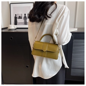 Detail view of olive green crossbody bag with vertical stitching and smooth leather finish