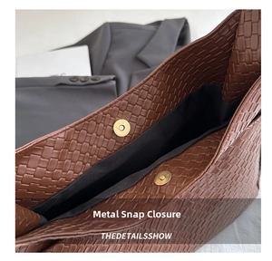Detail showing the golden magnetic snap closure on a brown woven texture tote bag