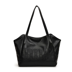 Large black tote bag with letter embossing and long shoulder straps on white background