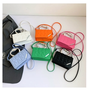 Close-up of quilted crossbody bags in various colors with sleek silver metal handles