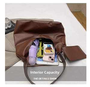 Interior detail of large brown tote bag showing capacity for iPad, umbrella and sunglasses