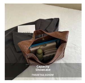 Deep brown woven tote showing large capacity with umbrella, wallet, and notebook