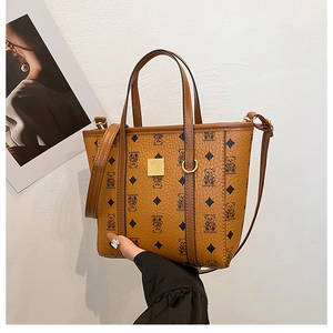 Détails du sac seau marron à motif ours, finitions dorées et bandoulière en cuir