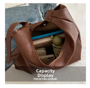 Detailed internal view of large brown leather tote bag showing spacious storage capacity