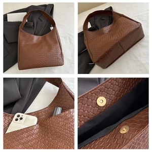 Detail of brown woven hobo bag showing magnetic closure and spacious interior for phone