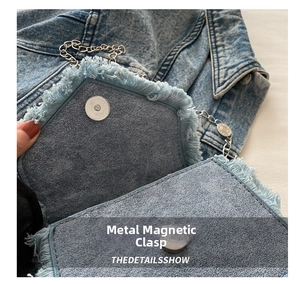 Detail of denim bag featuring raw fringe edges and a round metal magnetic snap closure
