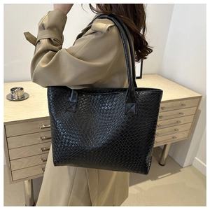 Large black woven texture tote bag for women shown with a trench coat for daily styling