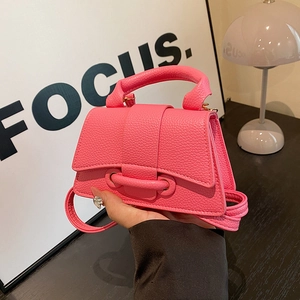 Hot pink mini handbag with lychee pattern texture and stylish tubular lock detail