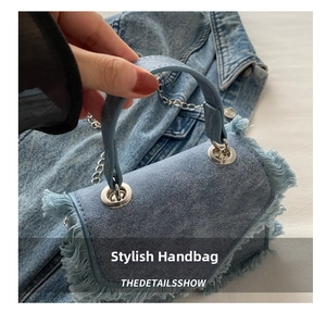 Close-up of blue denim mini bag with fringed edges and silver metal hardware details