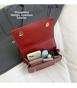Internal view of a red leather crossbody bag showcasing spacious storage for cosmetics