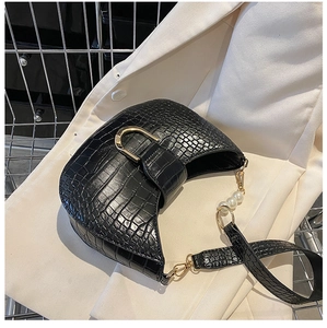 Detail of black crocodile texture hobo bag with pearl strap and gold metal buckle