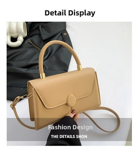 Close-up of khaki textured crossbody bag with metal ring buckle and curved handle