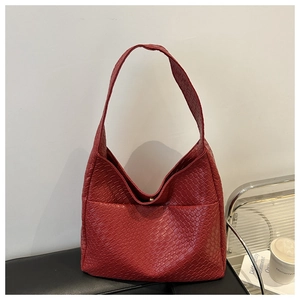 Chic red woven texture PU leather hobo shoulder bag displayed in a minimalist setting