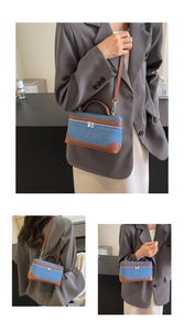 Macro shot of blue denim and brown leather details on a structured crossbody bag