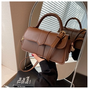 Detail of vintage brown rectangular handbag with elegant top handle and buckle strap detail