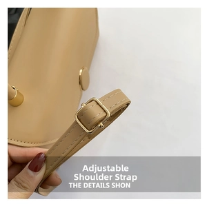 Detail of adjustable beige leather shoulder strap with premium gold square metal buckle