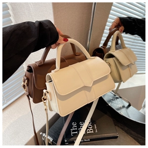 Detail view of vintage PU leather bags with round top handle and V-flap magnetic closure