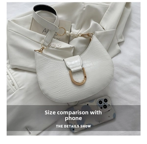White croc-effect baguette bag detail with pearl strap and phone for size comparison