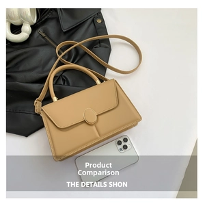 Detail view of khaki square bag with golden oval buckle and adjustable shoulder strap
