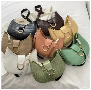 Detail of eight retro crocodile pattern bags with elegant pearl handles and metal buckles
