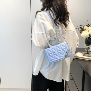 Pale blue quilted crossbody bag with stylish silver heart-shaped metal top handle
