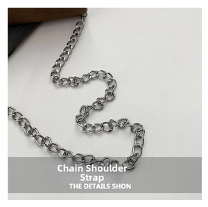 Detailed view of silver metal chain shoulder strap for a square crossbody bag