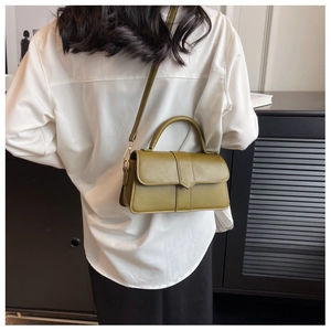 Model view showing the olive green leather crossbody bag with adjustable strap and gold hardware
