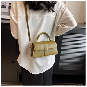 Olive green retro crossbody bag shown on a model for size and scale reference