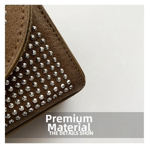 Macro shot of brown suede fabric with sparkling rhinestone inlay details on the handbag