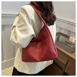 Detail view of the red woven leather texture on a vintage style hobo shoulder bag