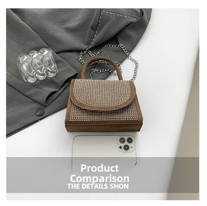 Mini brown suede handbag with silver rivets and metal chain shown next to a phone