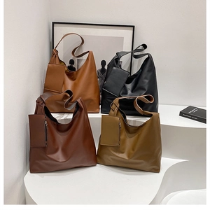 Four classic minimalist tote bags displayed on white stairs with matching mini pouches