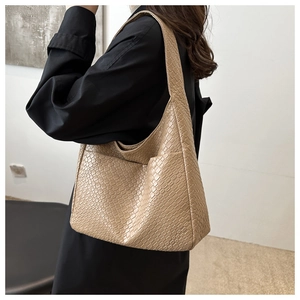 Detailed close-up of the vintage camel woven tote bag showing premium leather texture