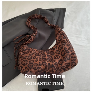 Detailed view of leopard print shoulder bag with ruched strap and size reference