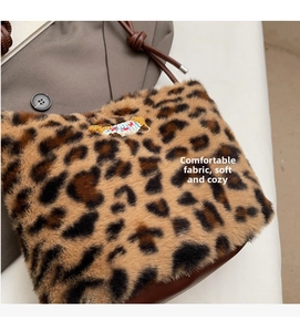 Detailed shot of soft leopard faux fur bucket bag with drawstring and embroidery