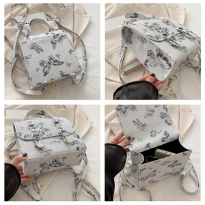 Detail view of white butterfly print backpack showing interior space and various angles