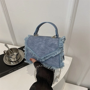 Minimalist light blue denim crossbody bag with fringe flap and silver chain strap