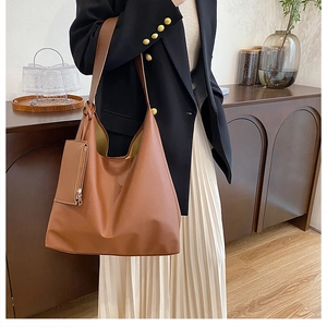 Brown hobo shoulder bag with a matching small zip pouch and soft matte leather finish