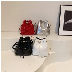 Collection of four drawstring bucket bags in glossy red, silver, black, and white colors